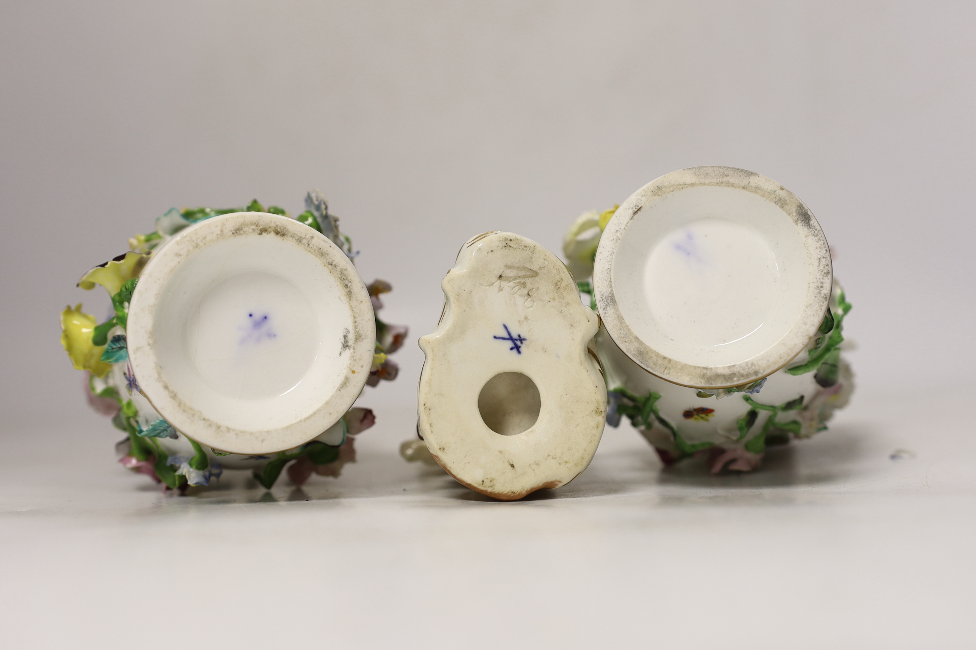 A pair of Minton flower encrusted bottle vases and covers, c.1835, and a Minton seated figure of a flower girl, c.1830-5, pseudo Meissen mark, bottle vases and covers, 22.5cm high